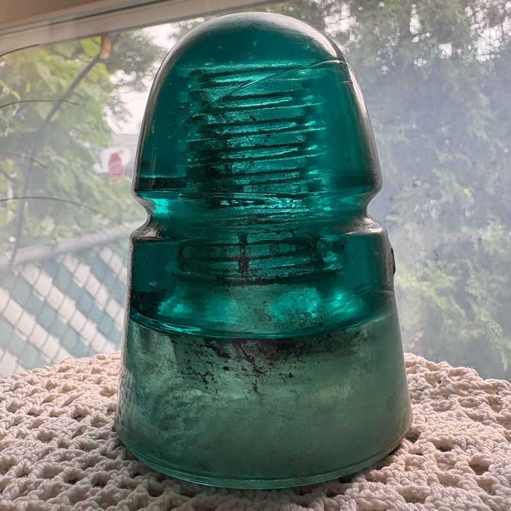 Old teal glass insulator